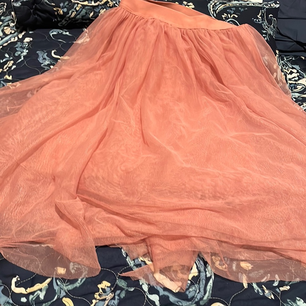 This is a 4 layers shirt with a pink base then a silky part on the 4th layer.